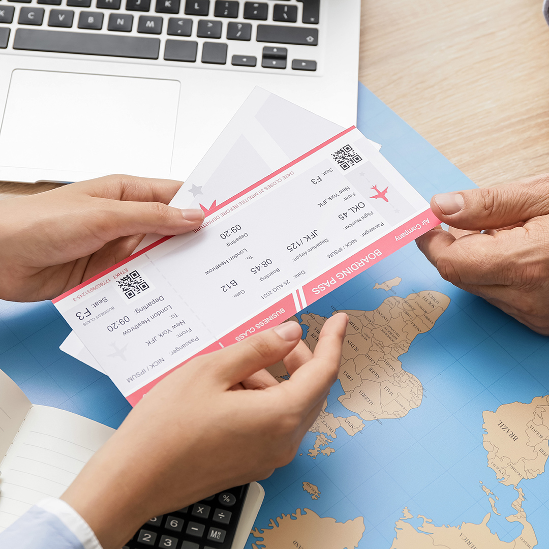 Travel agent giving client  tickets for future trip in office
